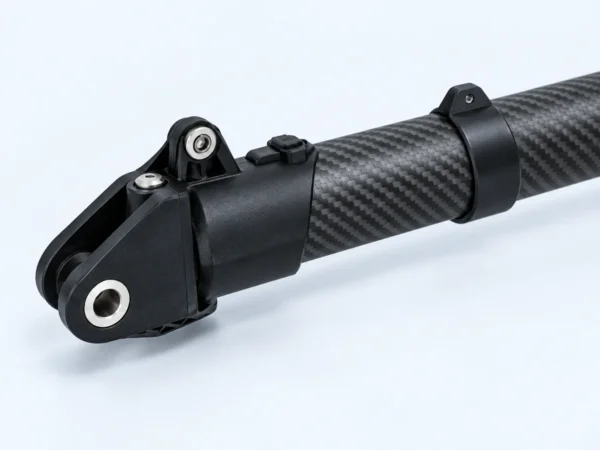 Close view of the folding-end fitting and pivot opening on a carbon-fibre drone arm